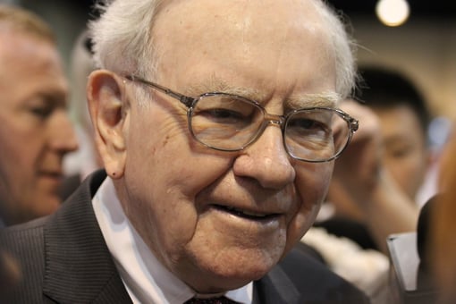 Warren Buffett in a crowd smiling.