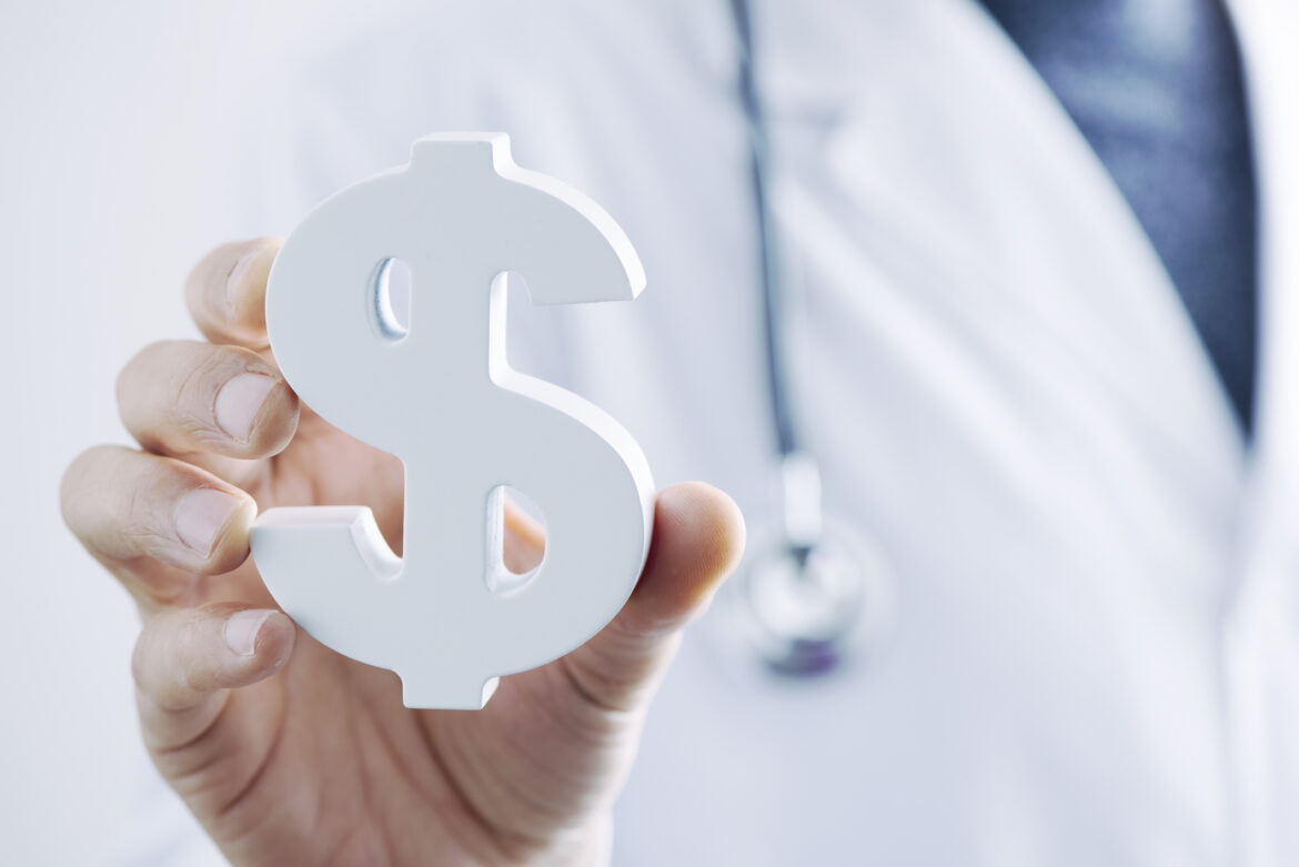 medical-professional-holding-dollar-sign-paperweight.jpg