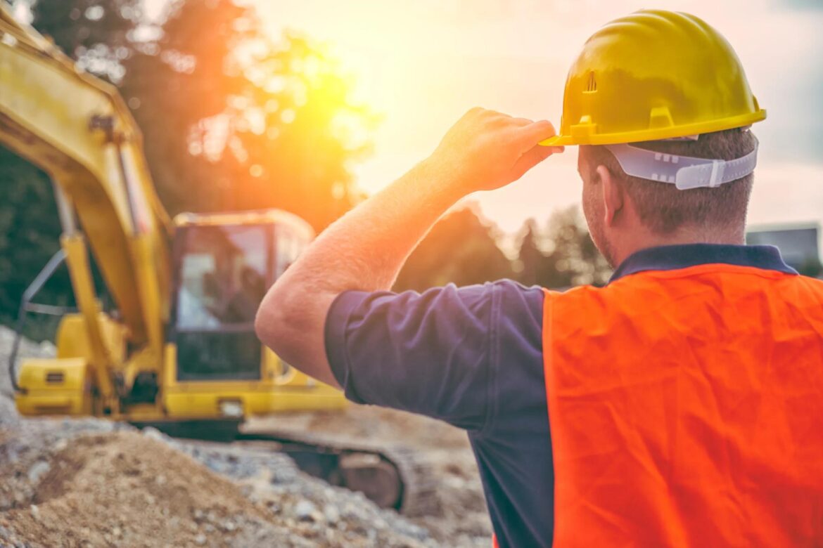 person-stands-in-front-of-heavy-machinery.jpg