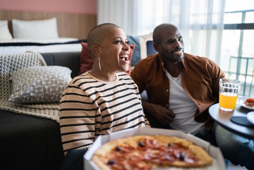 couple watches streaming media while eating