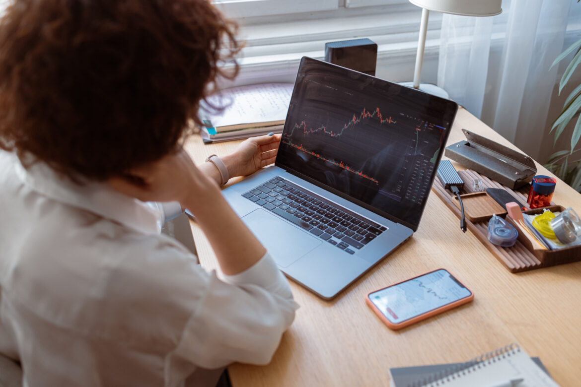 a-person-looking-at-a-stock-chart-on-a-laptop.jpg