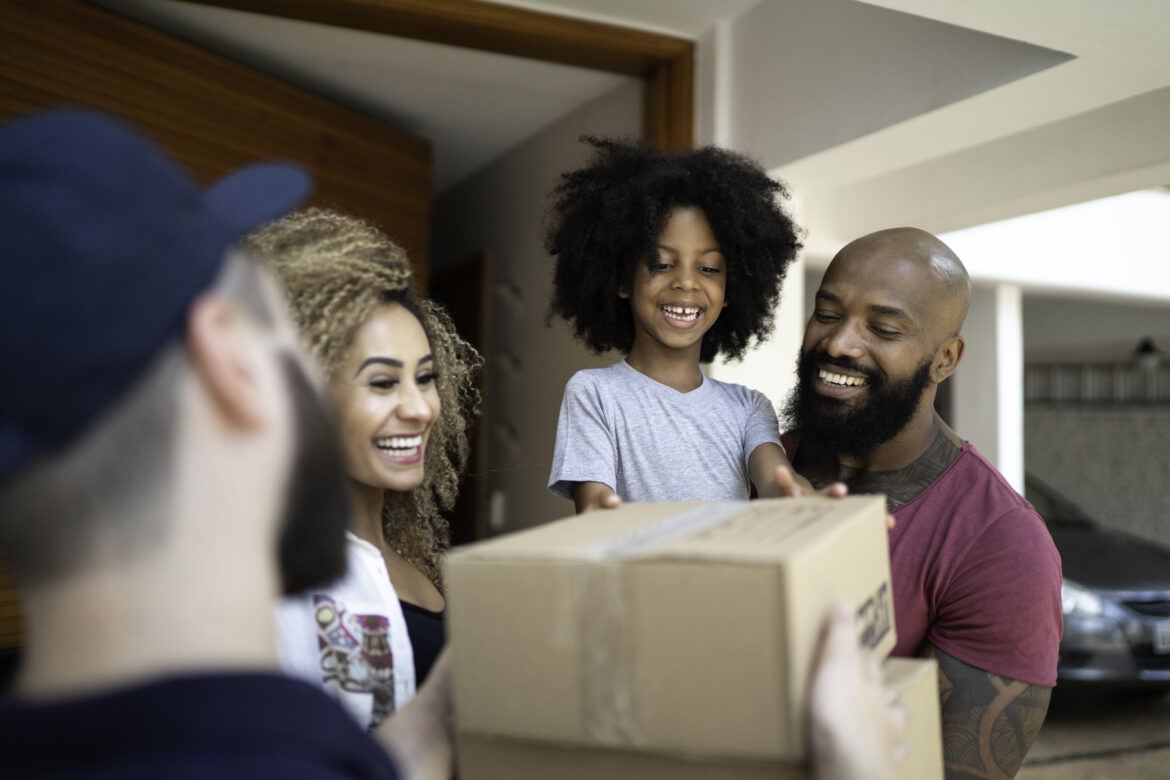a-smiling-family-accepting-a-package-from-a-delivery-driver.jpg