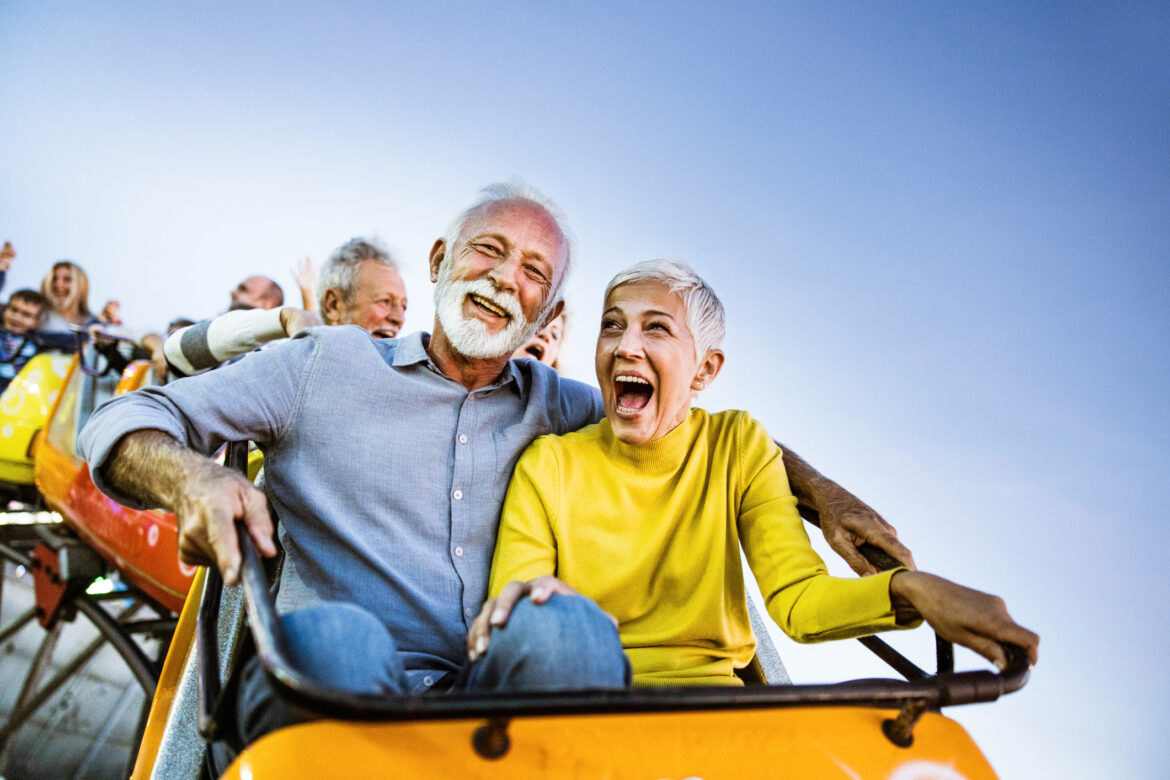 carefree-seniors-having-fun-on-rollercoaster-at-amusement-park.jpg