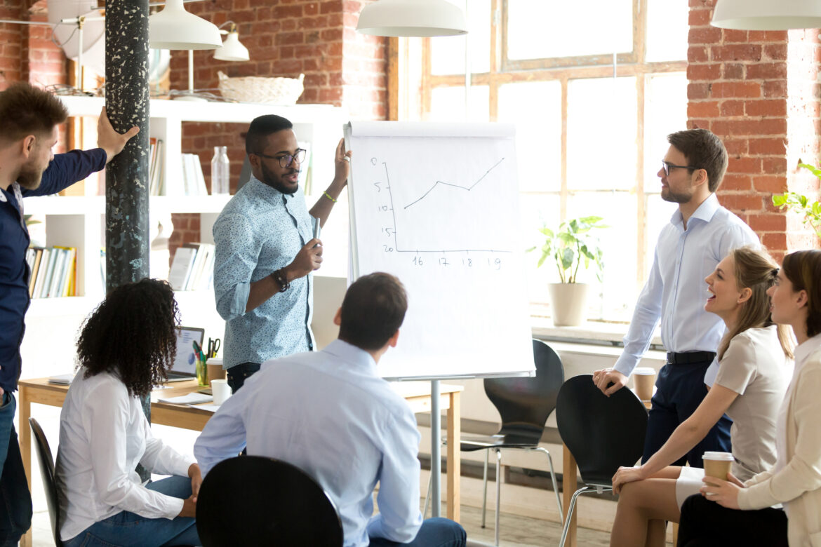 people-gathered-around-a-white-board-with-a-chart.jpg