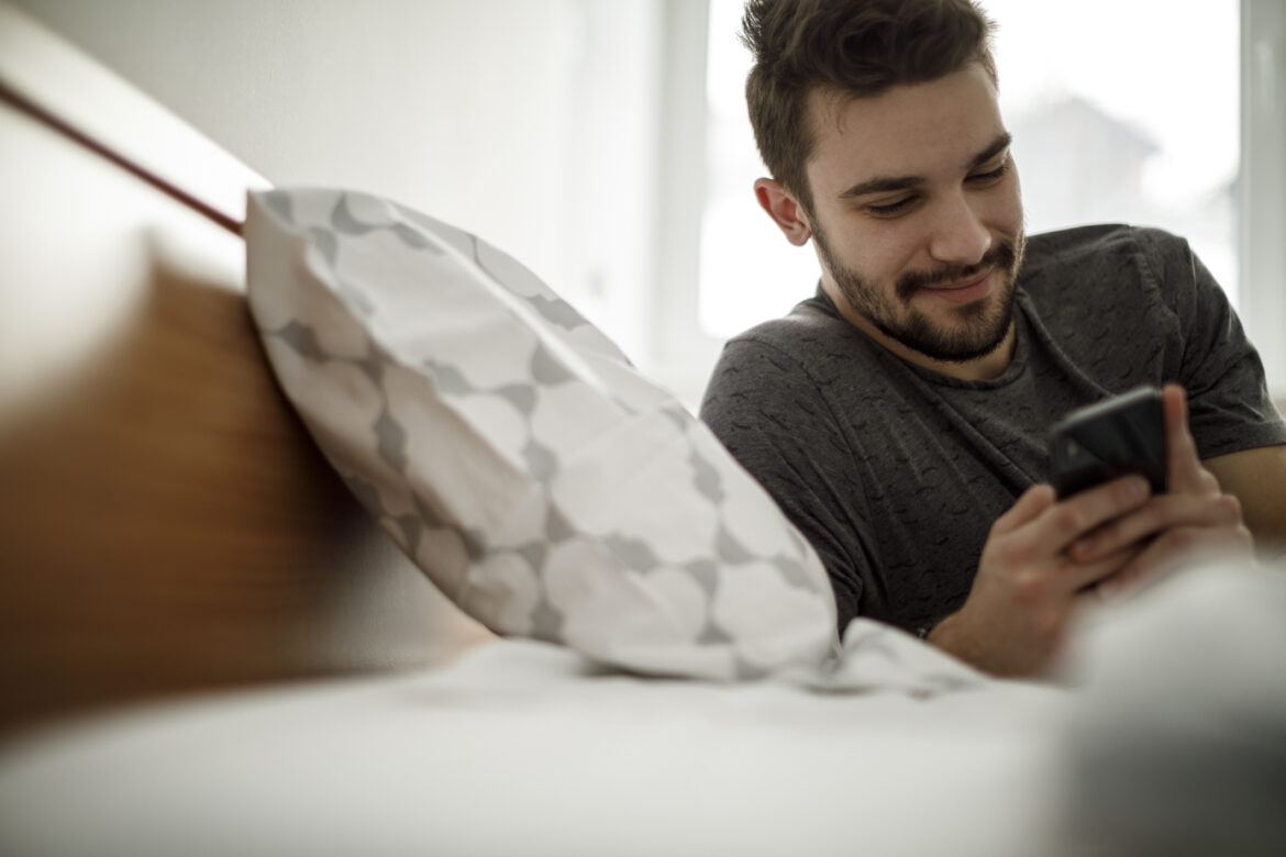 person-using-their-phone-in-bed.jpg
