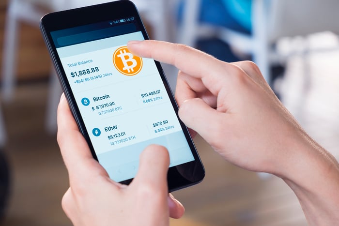 Person trading Bitcoin on a smartphone.