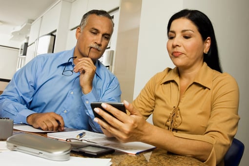 Middle-aged couple with calculator