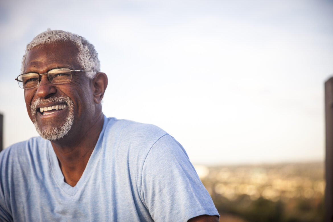 man-60s-smiling-outdoors-gettyimages-976789418.jpg