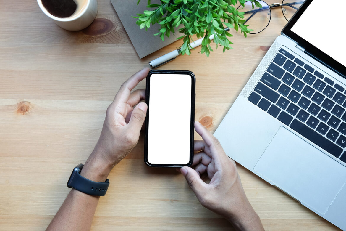 using-iphone-at-desk-with-apple-watch-on.jpg