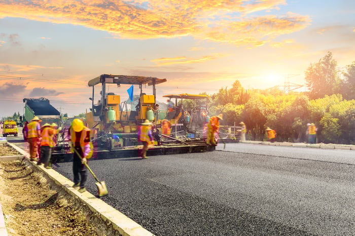 A road construction team on a highway.
