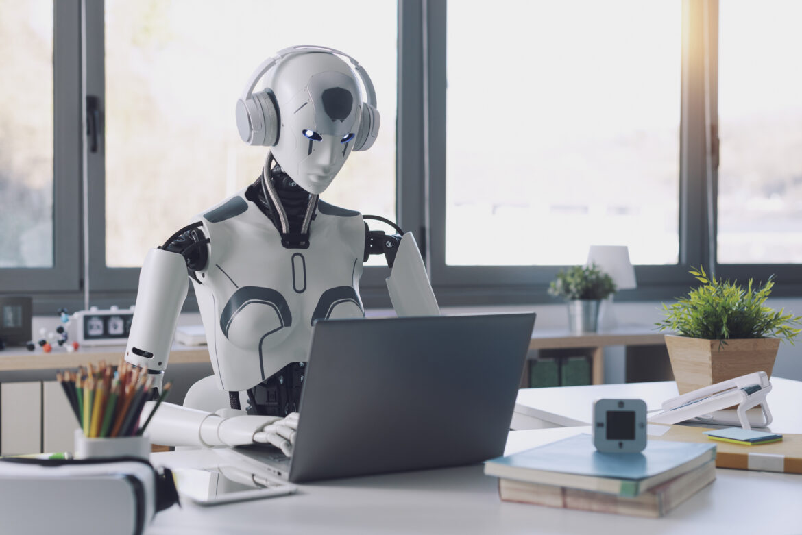 a-robot-with-headphones-does-work-on-a-laptop.jpg