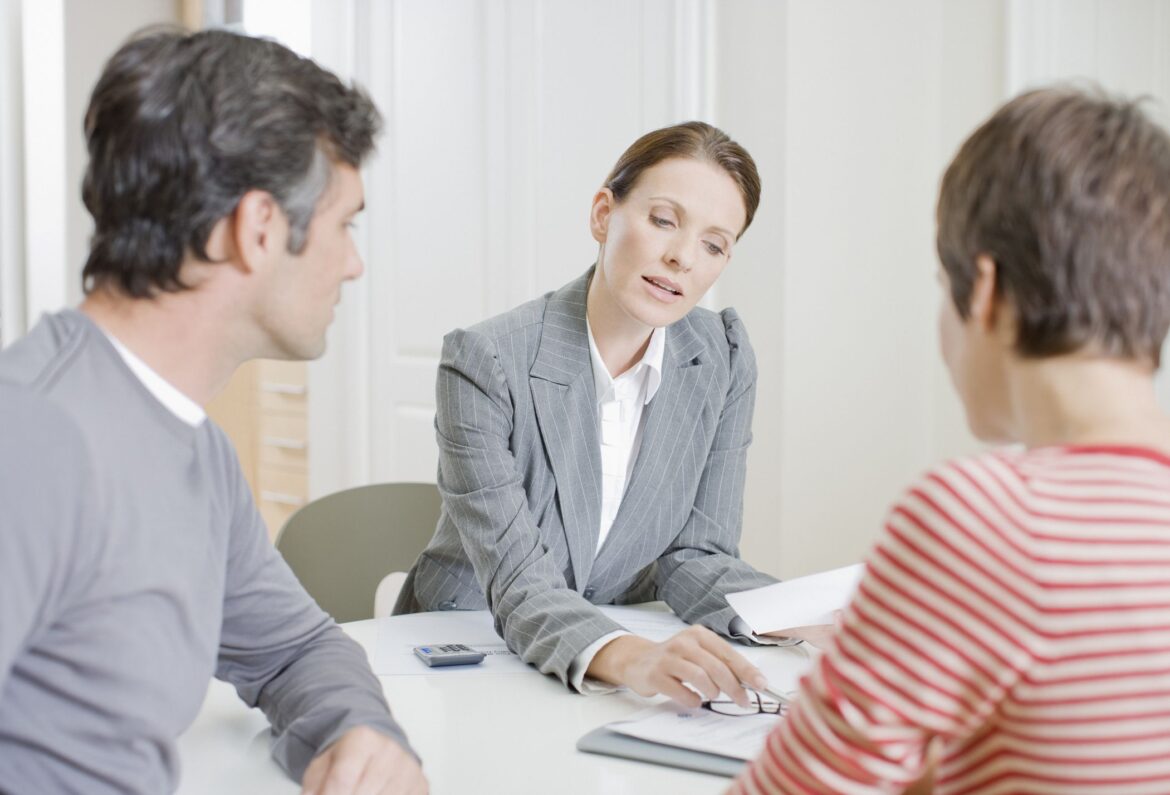 couple-looking-over-documents-with-financial-advisor-mortgage-lender.jpg