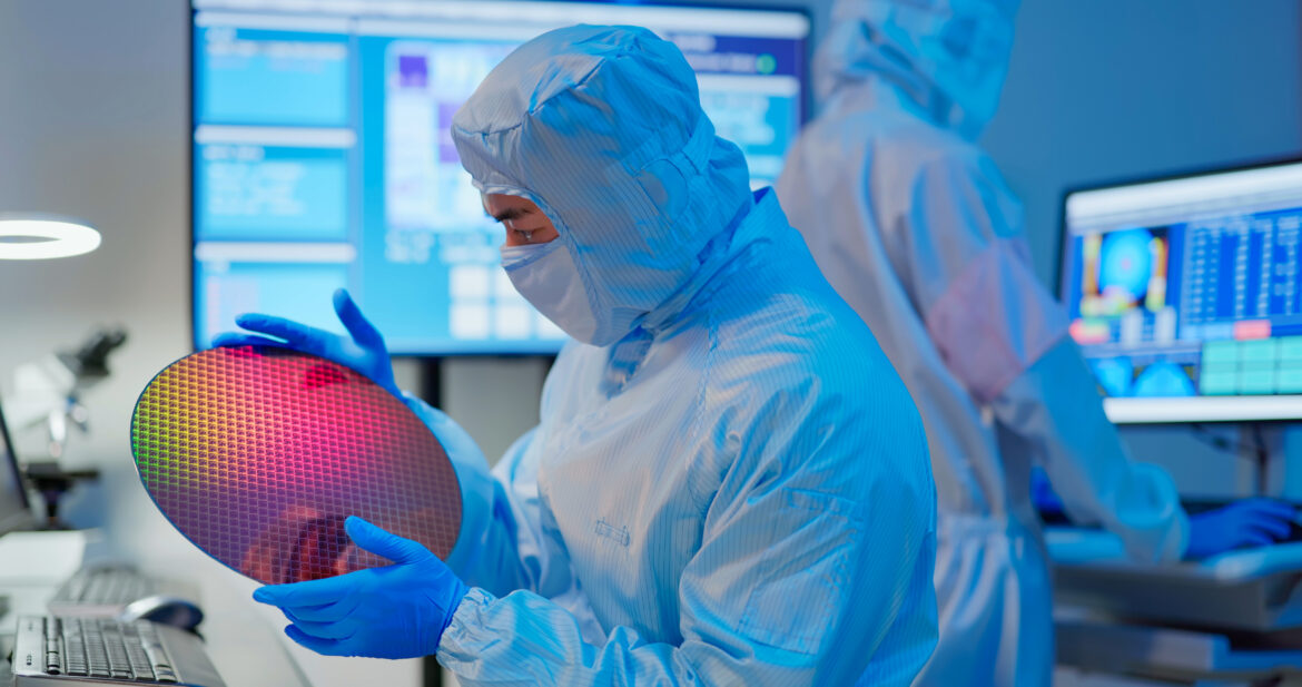 semiconductor-technician-with-wafer-in-manufacturing-plant.jpg