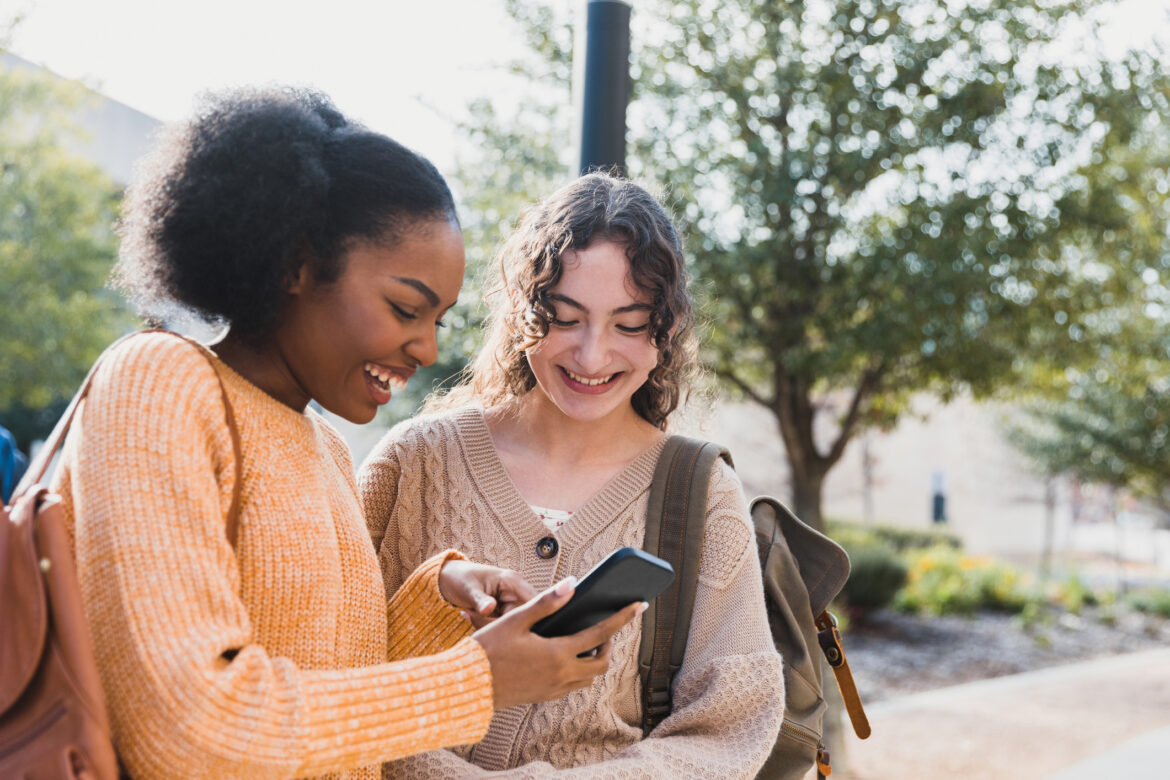 teen-shows-friend-something-on-their-smart-phone.jpg