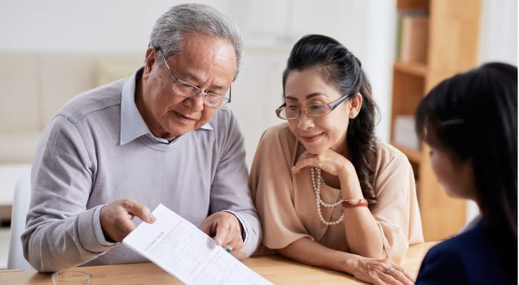 A couple reviews their retirement with their financial advisor. 