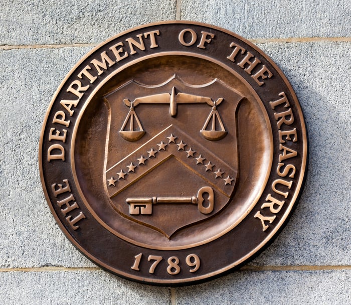 An emblem of the Department of the Treasury.