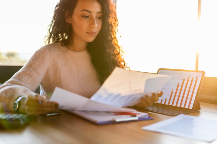 Person sitting at a desk looking at charts.