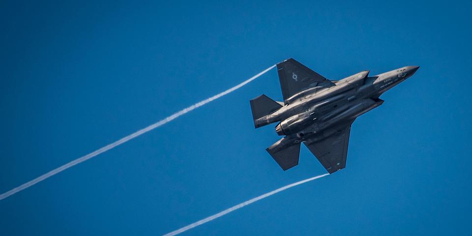 An F-35 Lightning II streaks across the sky while doing maneuvers to the Eglin Air Force Base runway.