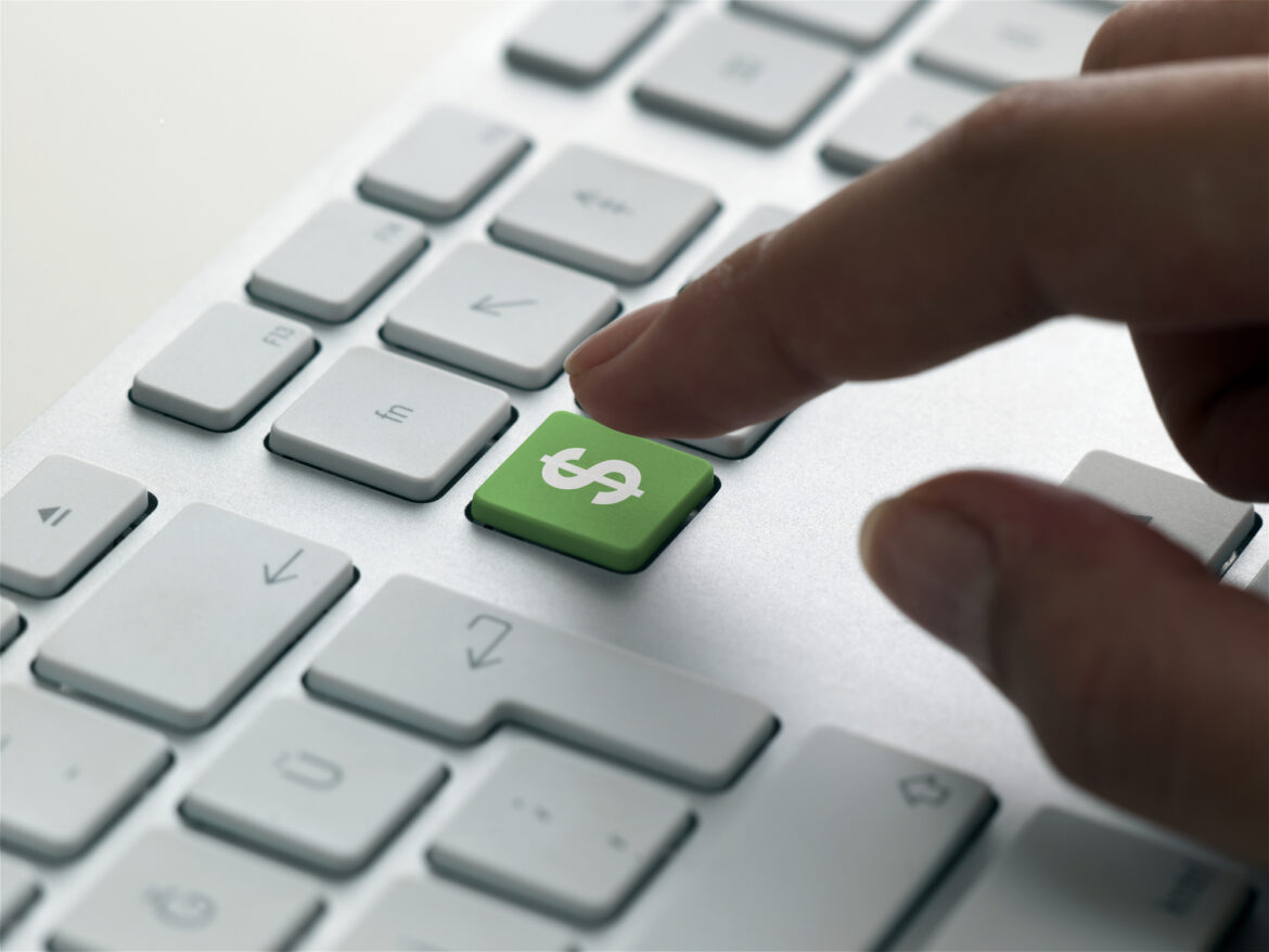 finger-about-to-press-a-green-dollar-sign-key-on-a-pc-keyboard.jpg