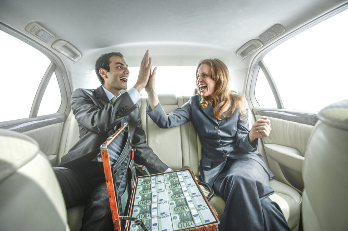 man-woman-celebrating-with-cash-in-a-car.jpg