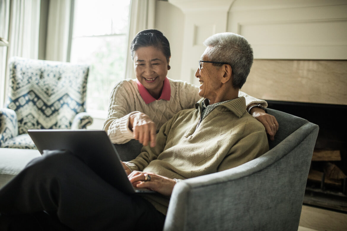 smiling-senior-couple-using-laptop-at-home.jpg