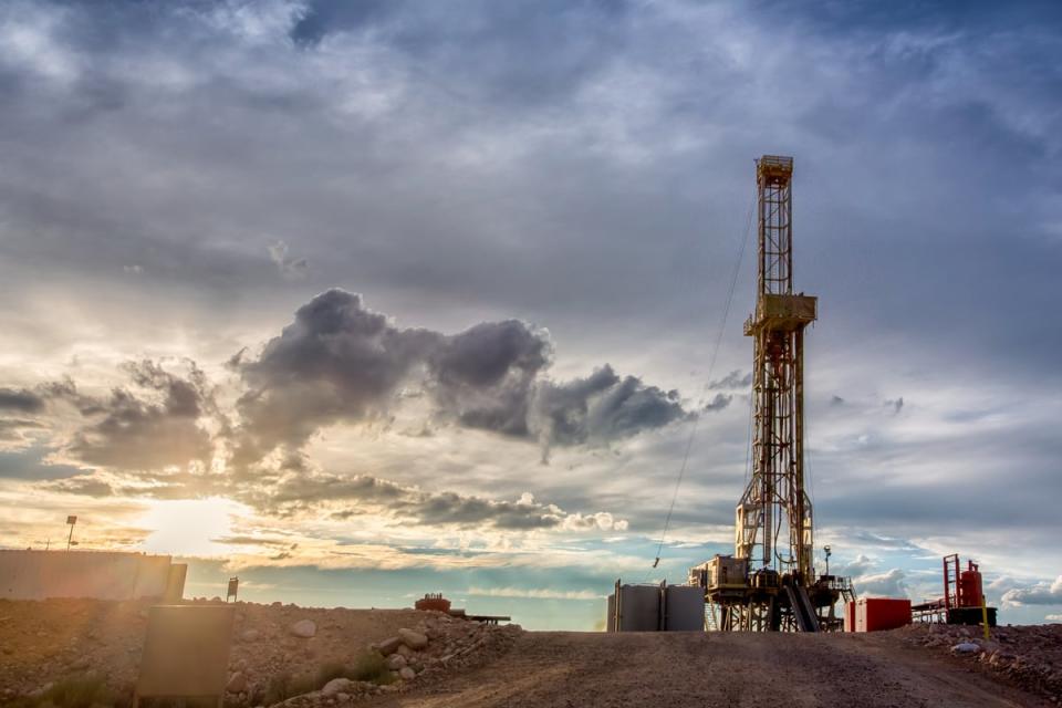 An oil well at sunset.