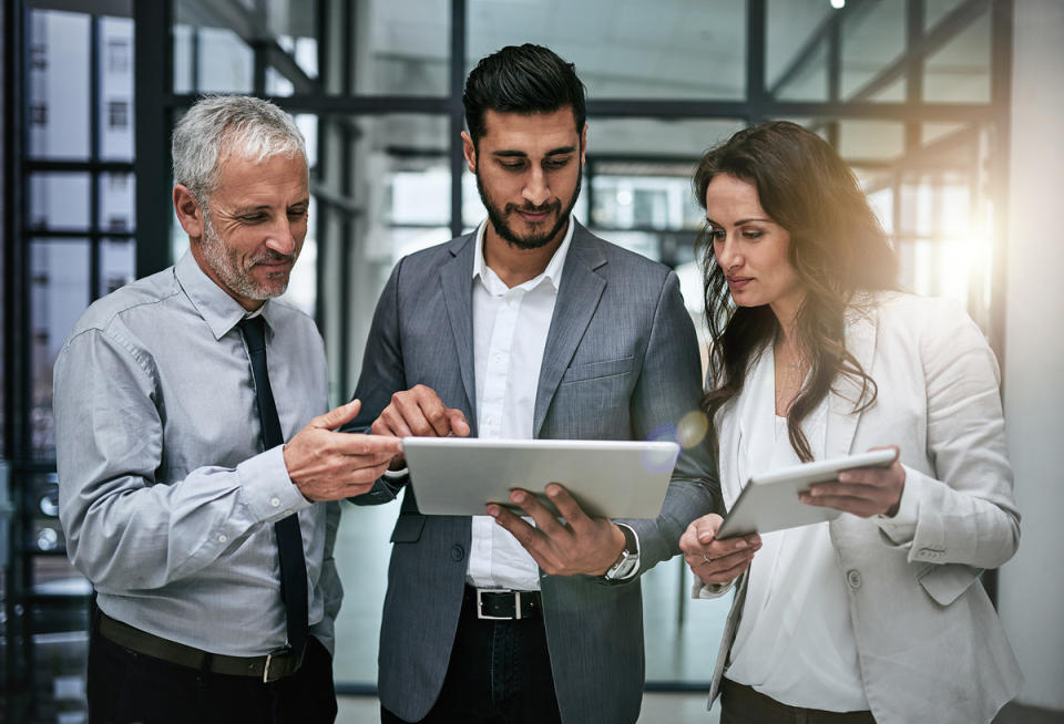 GettyImages-three business people looking at tablets