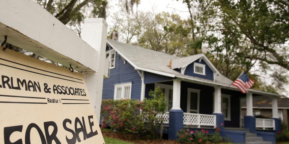A home with a "For Sale" sign.