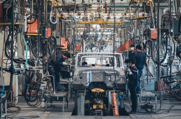 People working on a car assembly line.