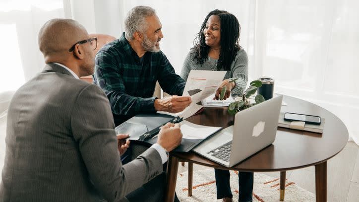 A financial advisor explains his fee structure and how he's compensated to a couple of prospective clients.