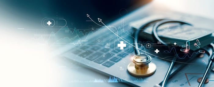 Medical equipment on top of an open laptop.