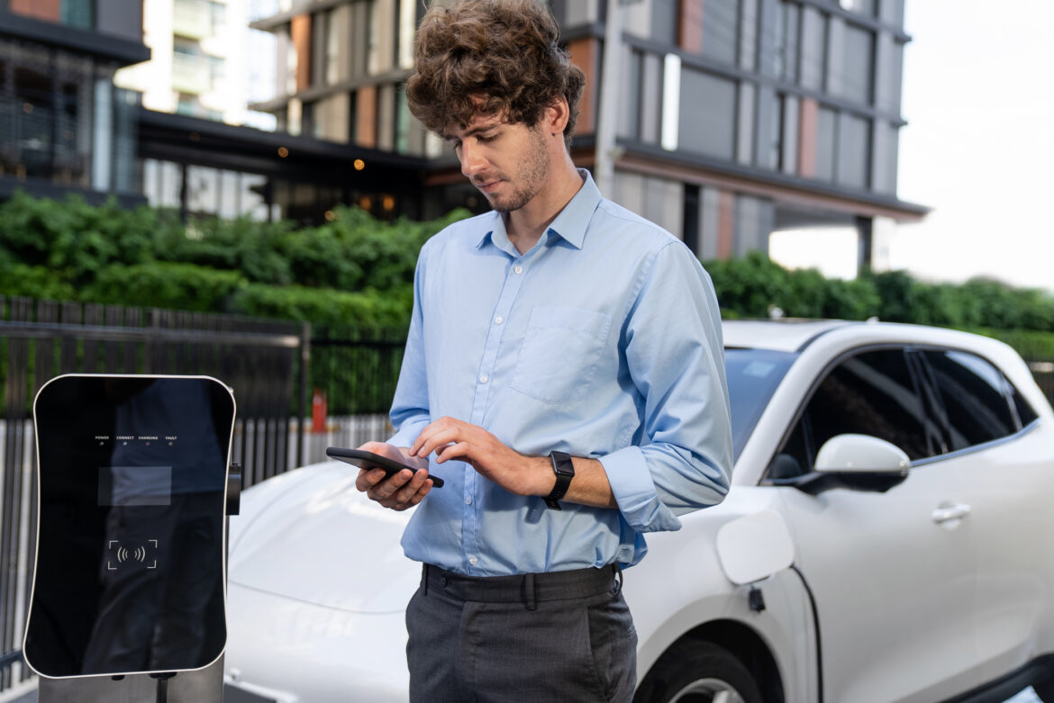 a-driver-checks-ev-charging-status-on-a-smartphone.jpg