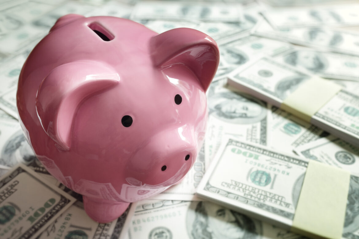 gettyimages-piggy-bank-on-a-pile-of-money.jpg