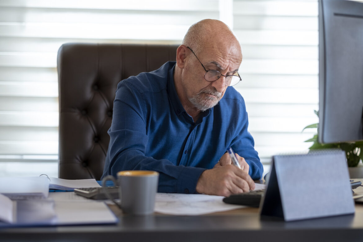 man-60s-at-deskgettyimages-1471388881.jpg