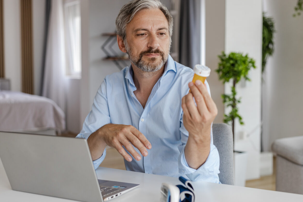 older-man-laptop-pills-gettyimages-1368091527.jpg