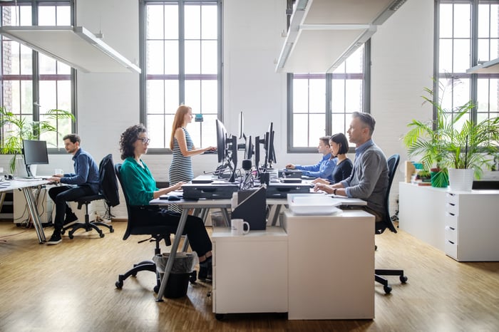 People working on computers in an office.