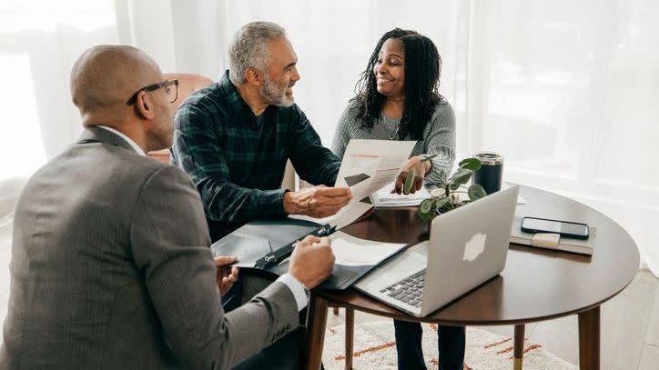 A couple goes over their beneficiary designations with an estate planning attorney.