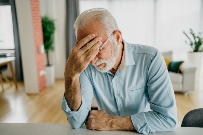 A person holding their face.
