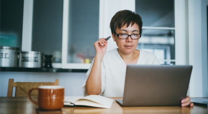 A woman reviews her IRA balance and calculates her Social Security benefits. 