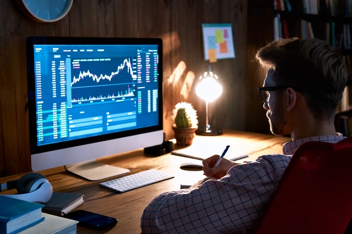 A person looks at a chart on a computer.