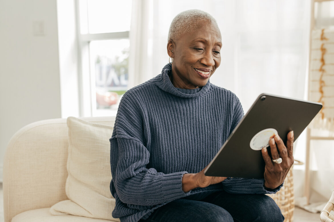 older-person-sitting-on-a-couch-looking-at-a-tablet.jpg