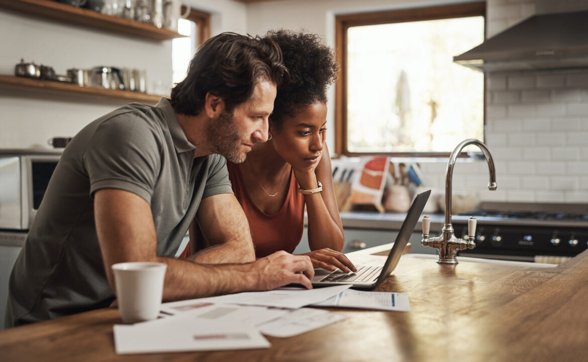 two-people-gazing-at-a-laptop-screen-while-in-a-kitchen.jpg