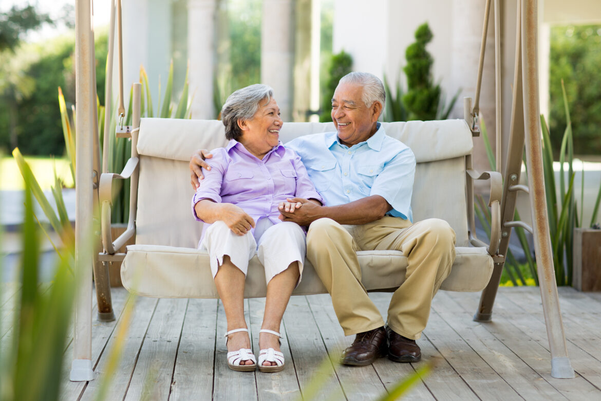 two-people-sitting-outside-on-a-swing-smiling.jpg