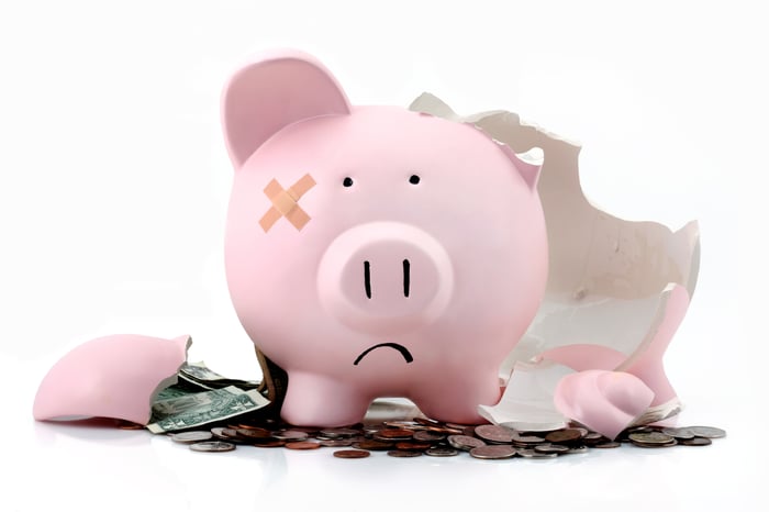 A broken piggy bank, frowning.