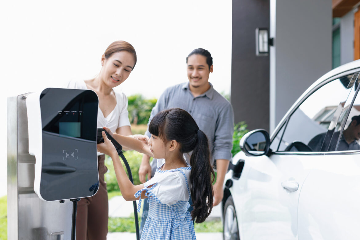 a-family-recharges-an-electric-vehicle-in-a-garage.jpg