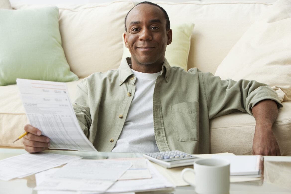 a-person-smiling-and-reviewing-their-finances.jpg