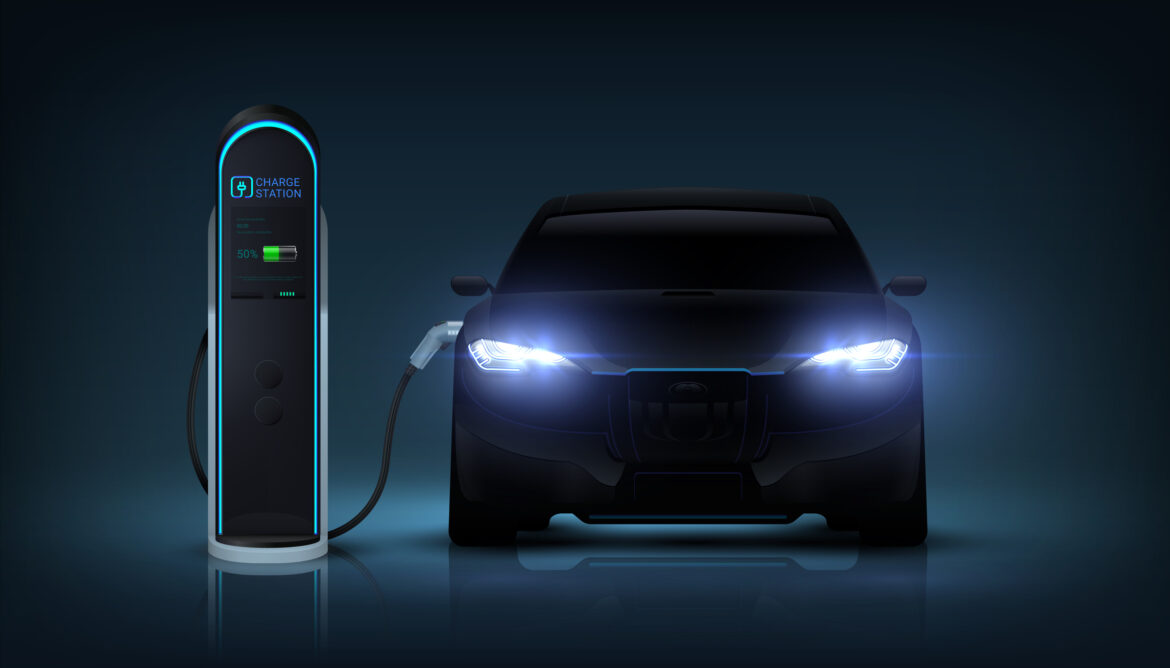 electric-car-with-headlights-glowing-and-plugged-into-a-charging-station.jpg