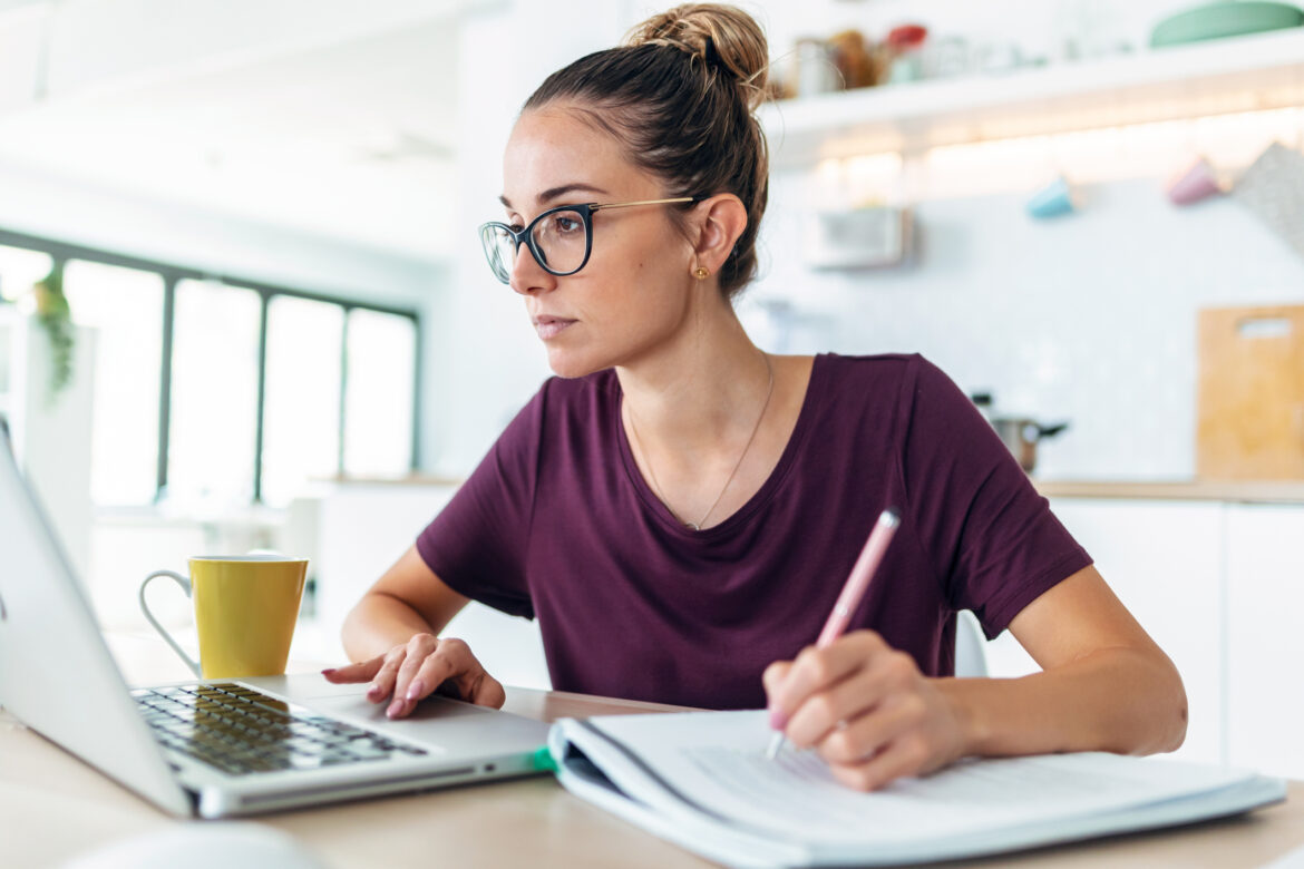 man-20s-laptop-holding-pen-gettyimages-1470308969.jpg