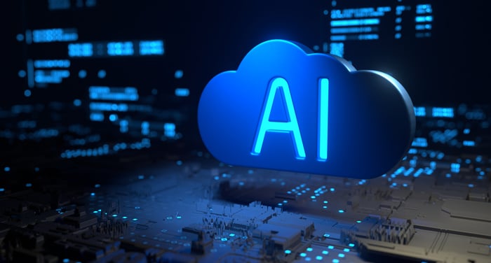 A data center is shown with an image of a cloud and the letters AI written in it.