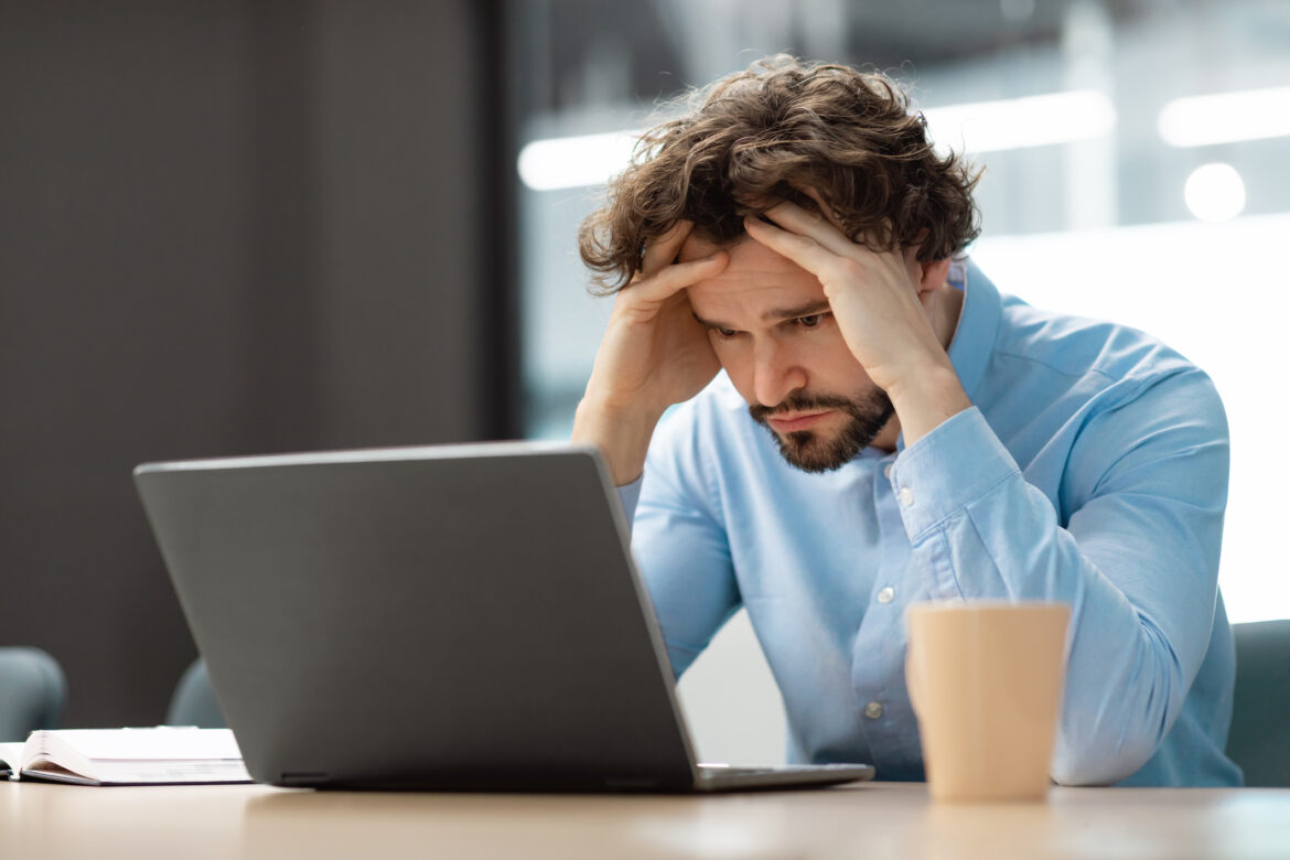 man-30s-laptop-upset-holding-head-gettyimages-1472661520.jpg